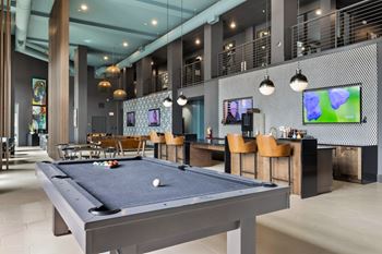 Gaming lounge with billiards, foosball, shuffleboard, and vintage arcade games